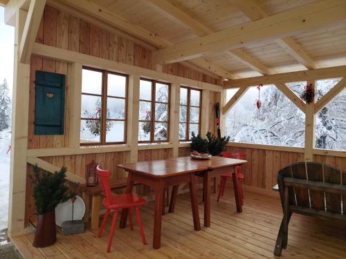 a room with a table and chairs in a cabin at Haus Enzian in Hinterstoder
