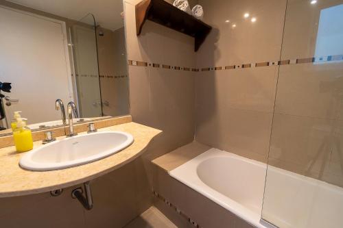 a bathroom with a sink and a shower at Moreno 820 Design Apartments in Buenos Aires