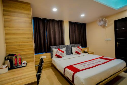 a bedroom with a large bed with red pillows at Hotel Pinkcity Prime & Chicago View Cafe in Jaipur