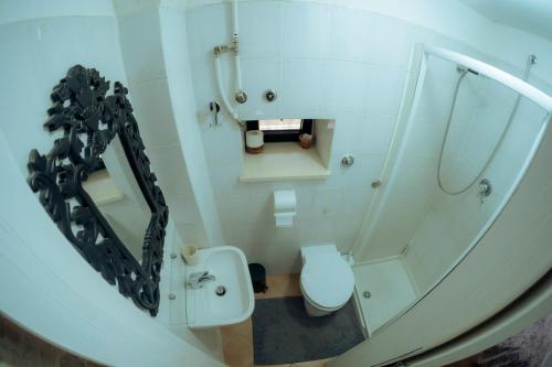 a bathroom with a white toilet and a mirror at La Torre Storica in Bitonto