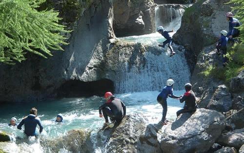 a group of people standing on rocks in a waterfall at Villa Harriet in Sovere