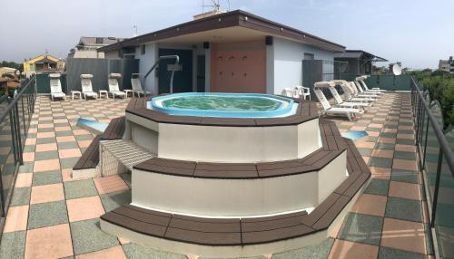 a hot tub on the roof of a house at Hotel Wega in Bellaria-Igea Marina