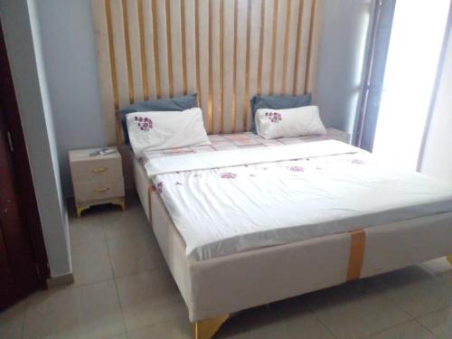 a bed with two pillows on it in a room at Lovely 1-Bed duplex house in Abidjan