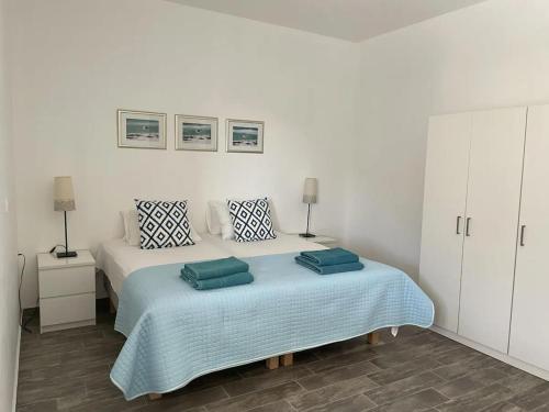 a bedroom with a bed with two pillows on it at Luxurious Villa on the famous glp cat sanctuary in Kinion