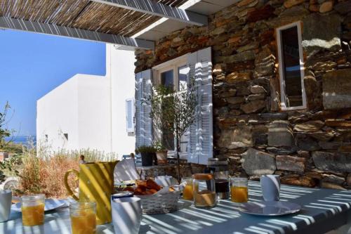 a table with a blue and white table cloth at Luxurious Villa on the famous glp cat sanctuary in Kinion