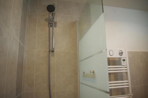 a shower with a glass door in a bathroom at Superbe Maison en baie du Mont St Michel in Vains