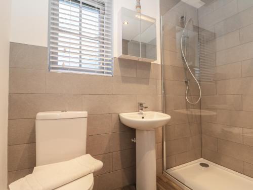 a bathroom with a toilet and a sink and a shower at Seadrift in Filey