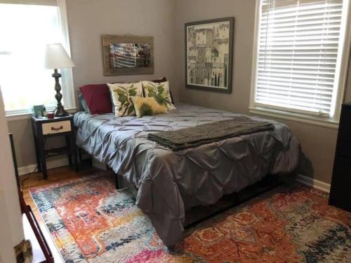 a bed sitting in a room with a window at 10 min Downtown-3 min Irvington in Indianapolis