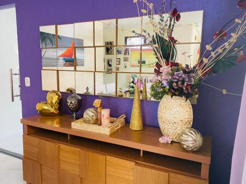 a shelf with vases and other items on it at Villa Paradise in Brazil - Praia de Guaratiba Prado-BA in Prado