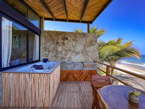 a bathroom with a bathtub and a table and a tableablish at DIEM Vichayito Beachfront Eco-Luxury in Vichayito
