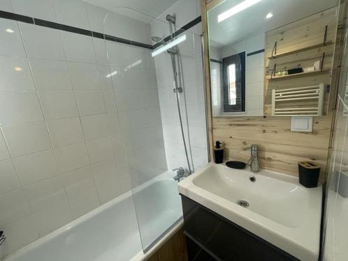une salle de bain avec une baignoire, un lavabo et une douche dans l'établissement Studio rénové avec balcon, au pied des pistes, WiFi et proche commodités - FR-1-502-552, à Tignes