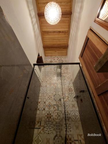 a hallway with a glass floor and a ceiling at Guest House Boki da Zezé in Marau