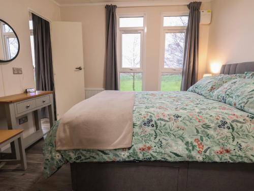 a bedroom with a bed and a window at Holmside in Market Drayton