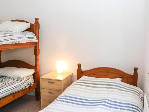 a bedroom with two bunk beds and a lamp on a night stand at Seafield in Ballymoney Cross Roads