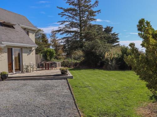 a backyard with a table and a lawn at Seafield in Ballymoney Cross Roads