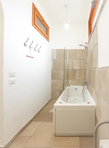 a bathroom with a white tub and a sink at Casa Vacanze Agape in Positano