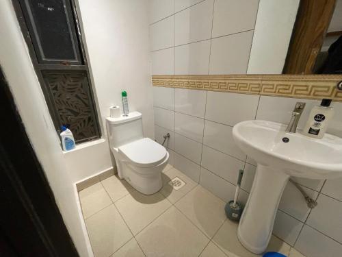 a bathroom with a toilet and a sink at Studio 403 in Kampala