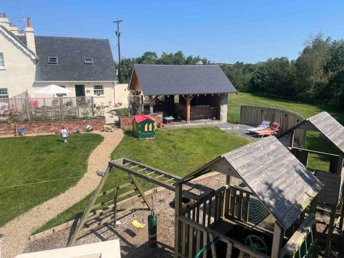 a backyard with a play area and a house at Garage loft conversion Killinchy in Killinchy