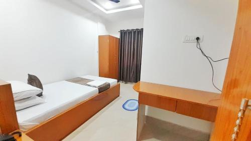 a small bedroom with a bed and a room with at The PENTHOUSSE near ION Exam Centre & Airport in Guwahati