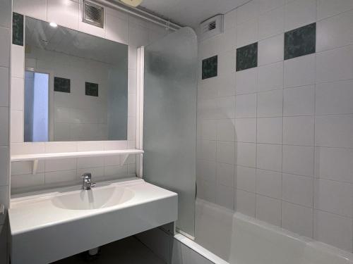 a white bathroom with a sink and a mirror at 3 pièces au Val Claret avec parking et wifi, proche pistes - FR-1-449-169 in Tignes