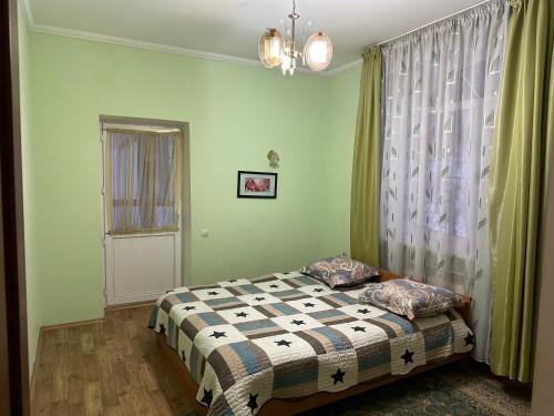 a bedroom with a bed and a window at Горная Сказка in Besqaynar
