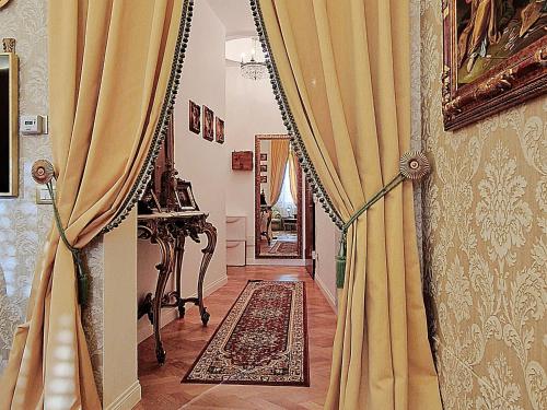 a hallway with yellow curtains in a room at La Baronessa in Palermo