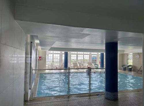 a large swimming pool in a large building at Residence de la Plage Pierre et Vacances in Le Crotoy