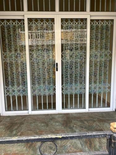 a glass door with a fence on it at VMKY apartment in Triolet