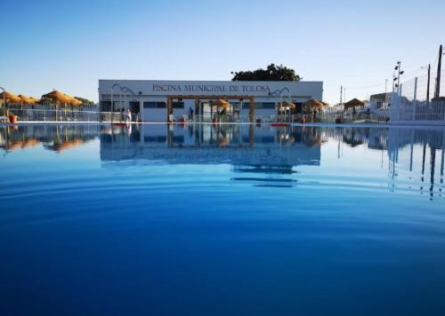 a large body of water in front of a building at Casa Castanheiro in Tolosa