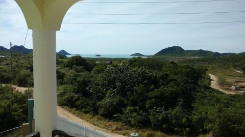 a view of the ocean from a balcony of a house at Zeus Estate Guesthouse in Grays Hill