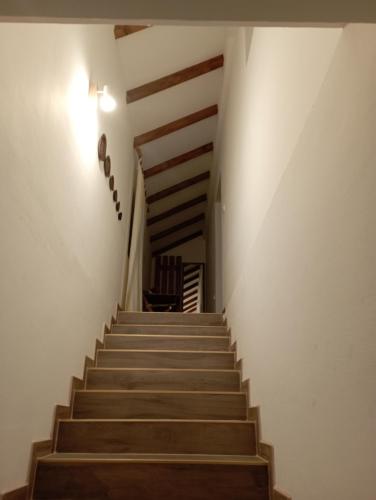 a staircase in a house with wooden stairs at GUESTHOUSE TARA in Kolašin