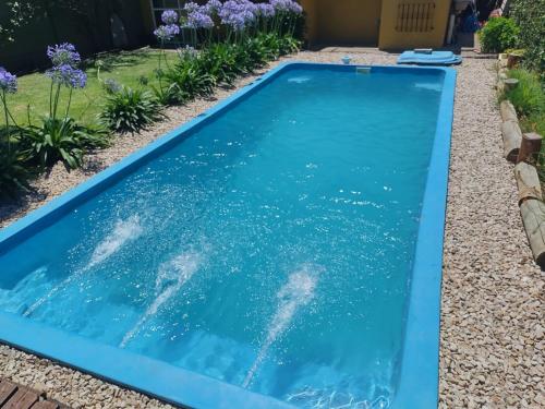 a pool with blue water in a yard at Alma Mía in Lobos