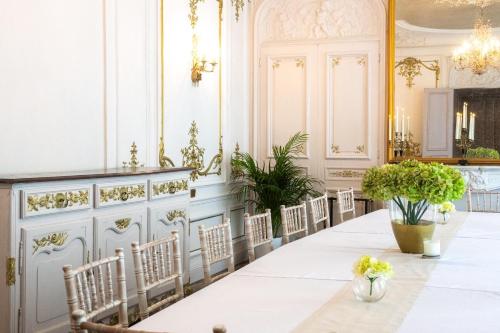 a dining room with a long table and chairs at Historic manoir in Vire Normandy elegance in a semi-rural setting ideal for groups and families in Vire