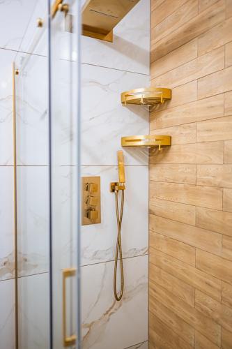 a bathroom with a shower with a shower head at Stone Hill C13 Szklarska in Szklarska Poręba