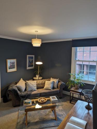 a living room with a couch and a table at Avon’s Rest in Stratford-upon-Avon