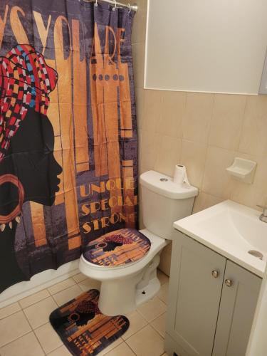 a bathroom with a toilet and a shower curtain at Traveler's Lodge In Newark City in Newark