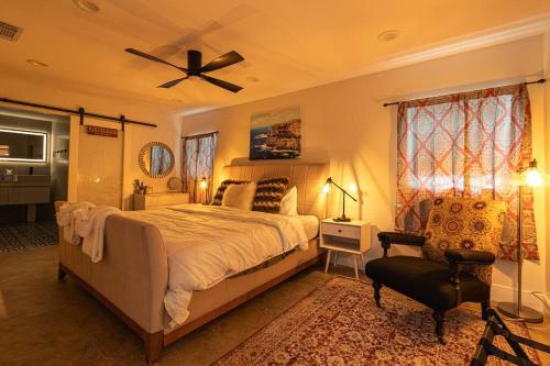 a bedroom with a large bed and a ceiling fan at Luxury Tampa home King bed 4BR in Tampa