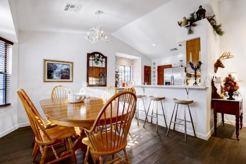a dining room and kitchen with a wooden table and chairs at Antlers - A Birdy Vacation Rental in San Antonio