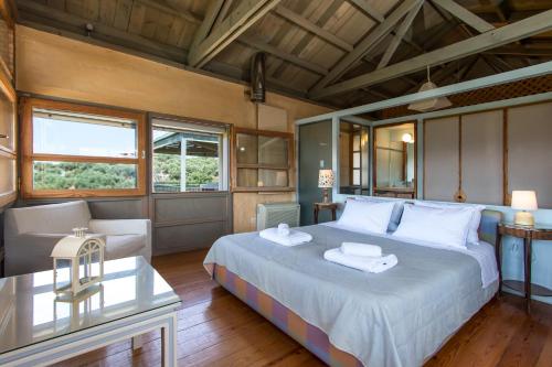 a bedroom with a large bed and a living room at Villa Catani in Kalamaki Chanion