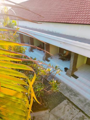 a view of a house with a window and a roof at Berlian Inn Kuta Beach in Kuta