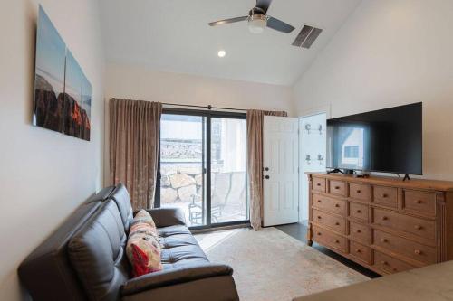 a living room with a couch and a television at Guest House - 1 bedroom North Salt Lake Stay in Bountiful