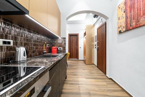 a kitchen with a sink and a counter at Royal Gold City Suites in Heraklio