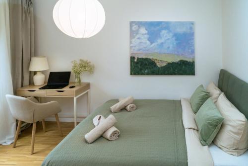 a bedroom with a bed with a desk and a laptop at NEW-Rita - atemberaubenden Wasserfälle in Triberg