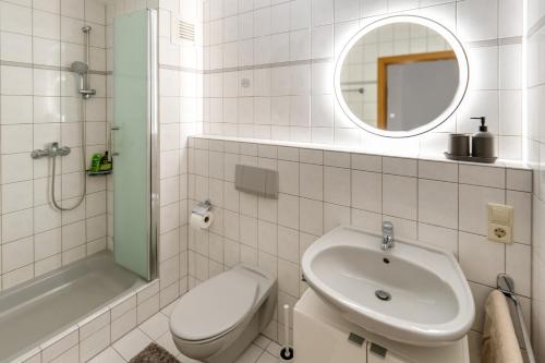 a bathroom with a sink and a toilet and a mirror at NEW-Rita - atemberaubenden Wasserfälle in Triberg