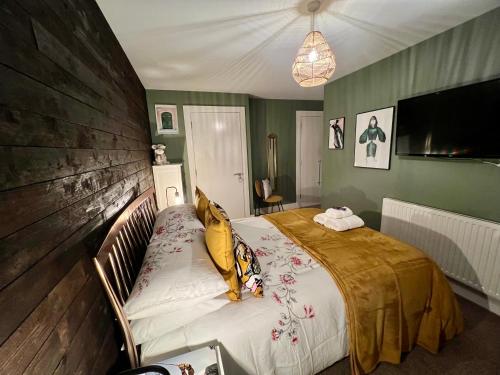a bedroom with a bed with a wooden wall at Sailortown BED & BREAKFAST in Belfast