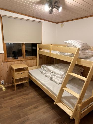 a room with two bunk beds and a ceiling fan at Joy Stugan Näsfjället in Sörsjön
