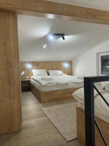 a bedroom with two beds and a ceiling at Apartmani Andjela in Jahorina