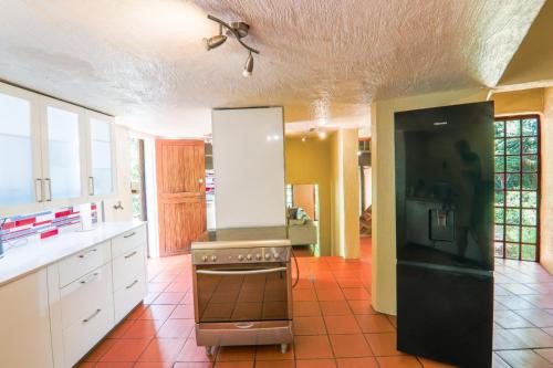 a kitchen with a stove and white cabinets at Brooklyn's Holiday Home in Pretoria