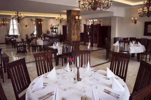 a dining room with a table with white table cloth at Orient Palace in Bielany Wrocławskie