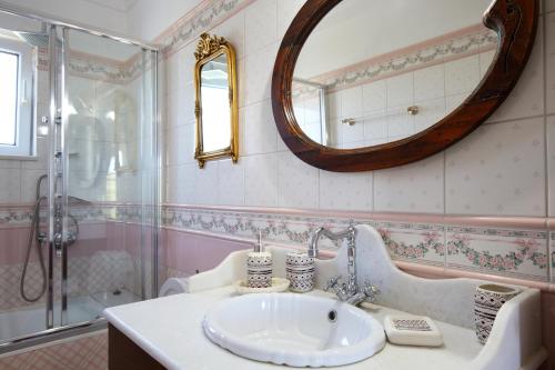 a bathroom with a sink and a mirror at Elite Escape in Tsoukalades